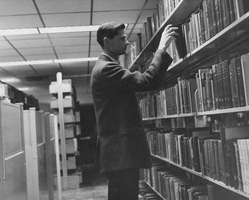 Patron in King Library Annex, showing the stacks and graduate carrels