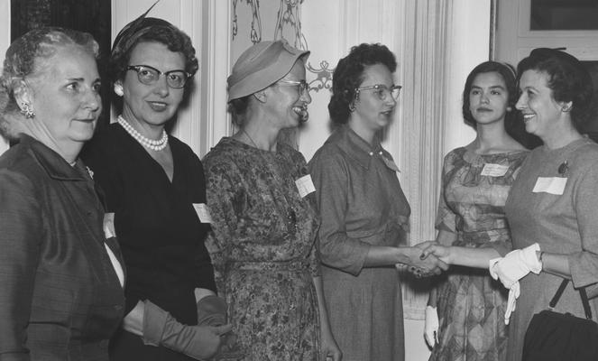 Inside Maxwell Place; September 23, 1958, University of Kentucky's Women's Club. From right: unknown, Bonnie Bradley, Mrs. Frank G. Dickey, E. Diashun, and two unknowns. This is a Herald Leader Photograph. Received October 8, 1958 from Public Relations