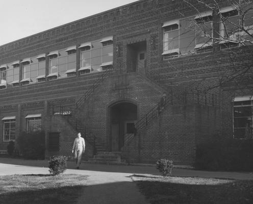 Student, John Troy is walking near the Engineering Building. Received December 5, 1957 from Public Relations