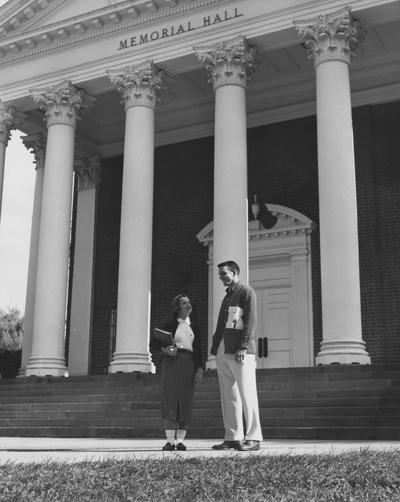 Lowell Hughes standing with and unknown female in front of Memorial Hall. Received October of 1957 from Public Relations