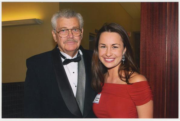 Rachel Watts, student government president, and an unidentified man are at a ceremony for the reopening of the Main Building