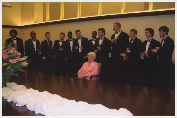 Betty Rosenthal is with the UK men's choral group the Acoustikats at a ceremony for the reopening of the Main Building