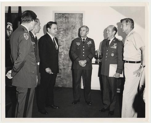 Professor Vince Davis (dark suit), Director of the Patterson School of Diplomacy and International Commerce, is at the National War College in Washington DC.  In the center is the Commandant with is two aides at the left.  At the right are General W. Y. Smith, USAF, and LTG Bob Guard, USA.  Davis was a guest lecturer