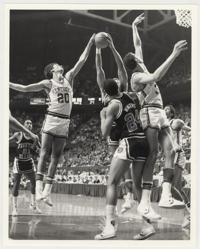 The University of Kentucky Men's Basketball Team versus the University of Illinois at Rupp Arena.  The Kentucky Players from the left:  Jim Master (#20) Sam Bowie, and Kenny Walker