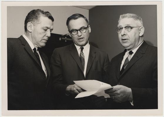 Members of the Energy Subcommittee of the Kentucky Science and Technology Commission discuss the agenda of a meeting held at the University of Kentucky.  From the left:  Chairman Sam Cassidy, Executive Director D. W. A. Lambertson, and Dr. Ronald Reitmeier