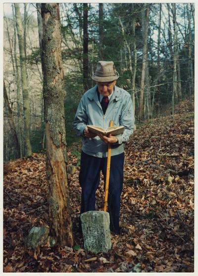 Dr. Thomas D. Clark is reading at William Baker's grave at the mouth of Gabriel, Right Fork of Buffalo, Owsley County, Kentucky