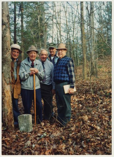 From the left:  Jess Wilson; Dr. Thomas Clark; Stanley Deizarn; A. B. Couch, Postmaster at Mistletoe; and Dennie Campbell.  They are at William Baker's grave at the mouth of Gabriel, Right Fork of Buffalo, Owsley County, Kentucky