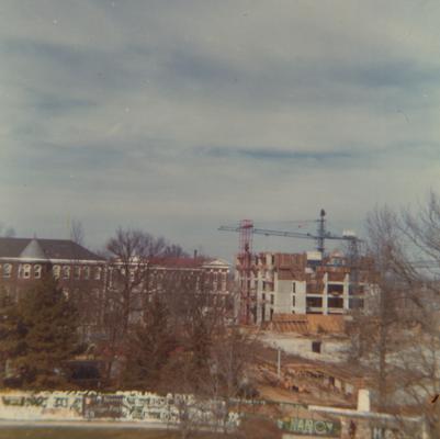 A color photo of the construction of Patterson Office Tower (right) near the Administration Building (center) and Miller Hall (left). This photo was taken from the window in room 518 in King Library on February 5, 1968 and donated by Terry Warth