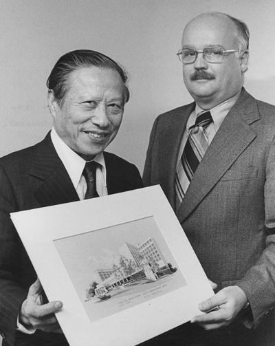 Dr. Peter Bosomworth (Chancellor), on the right, and an unidentified man on the right are holding an architectural drawing of the Medical Center. Received April 12, 1996 from the Medical Center Chancellor