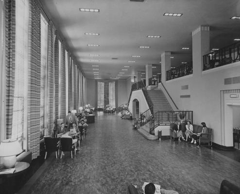 Inside of Student Center; students reading papers and talking