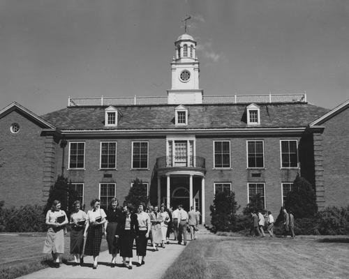 People walking to and from the Taylor Education Building. Received June of 1952 from Public Relations