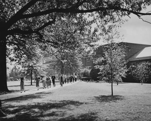 Pence Hall, Mining Lab and Engineering Lab; students walking from class, holding books. Photographer: Ben. L. Williams. Received October 29, 1949 from Public Relations