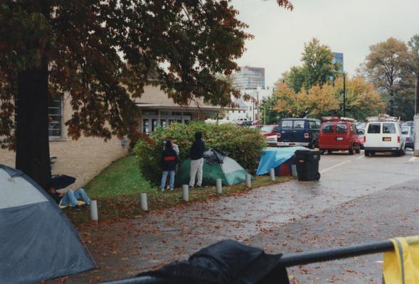 Unidentified people standing and camping out near Memorial Coliseum for 