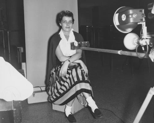 Female student getting picture taken for ID card. Received September of 1957 from Public Relations