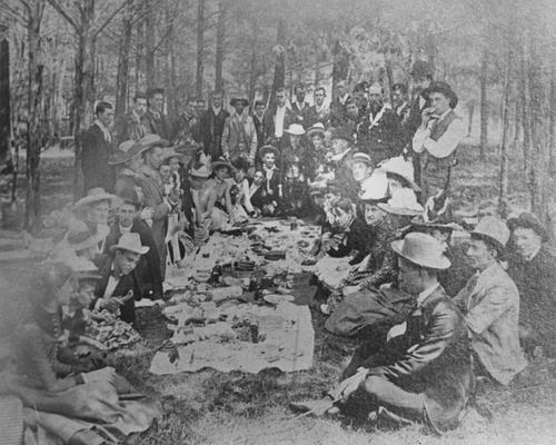 Picnic, showing Augustus O. Stanley (front left corner) leaning with a chicken leg in hand. This photo appeared in the May 9, 1965 Herald-Leader