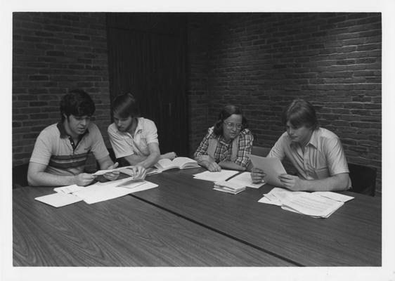 Mr. Mancuso (left) and Mr. Jones (right), an unidentified woman and an unidentified man are studying