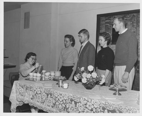 John Davis (third from right), Carolyn Jones (second from right), Gregg Rhodemyre (second from right), and an unidentified female student at a tea party in the Student Union Building