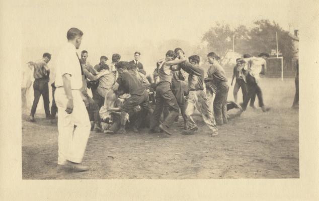 Men in a tug-of-war between the Freshmen and Sophomores at Clifton Pond