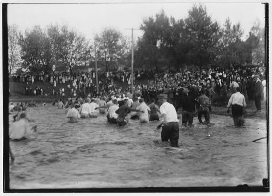 Losers wading out of Clifton pond after the 1914 tug of war; The Freshmen triumphed in this contest held in October