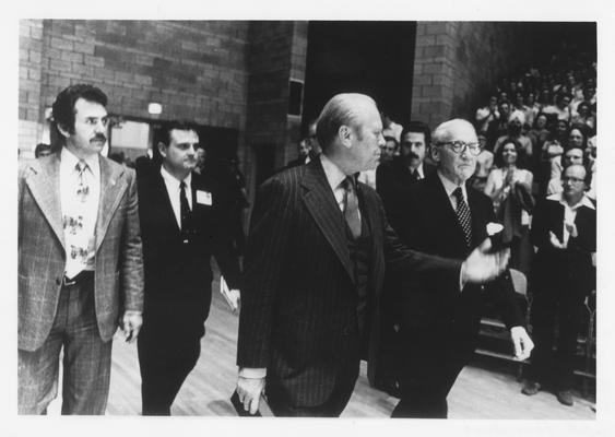 Former President Gerald Ford and United States Senator John Sherman Cooper spoke to a crowd of 7,000 in Memorial Coliseum in 1977; Vince Davis (in dark suit), Director of the Patterson School of Diplomacy in 1971 walks behind Ford and Cooper
