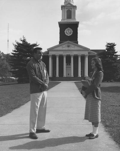 Male and female student talking in front of Memorial Hall