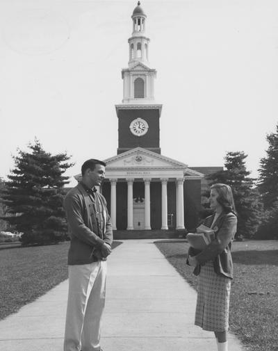 Male and female student talking in front of Memorial Hall