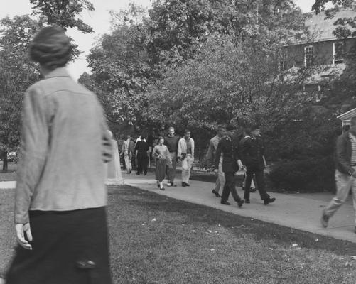 Students walking to class; Female student facing camera is Ann Hoggman