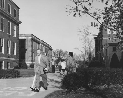 Students walking to class; McVey Hall and Journalism building are on the left; Library, Pence Hall, and the temporary Chemistry building are on the right