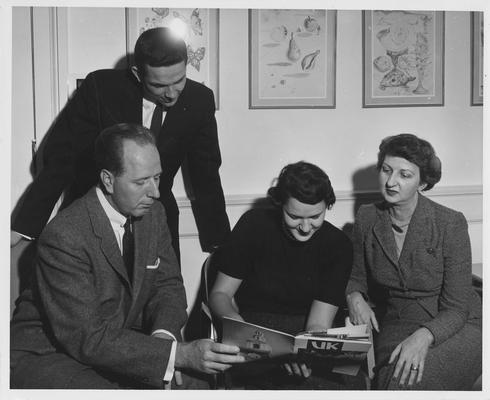 Dean Leslie Martin, professor in the College of Education and Dean of Men, seated, with others