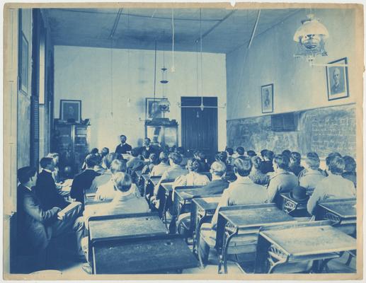 Students sit in a class listening to the professor
