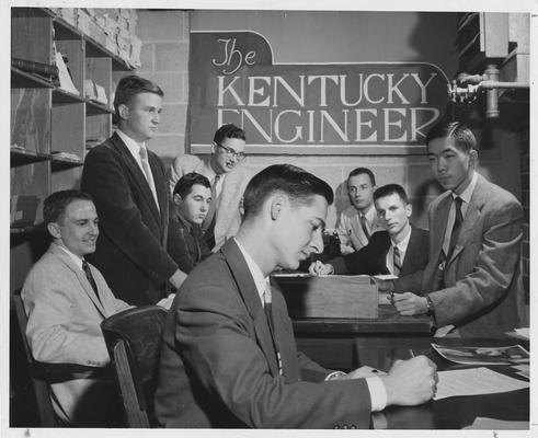 William Lowry in the foreground; and from left to right: Robert Adams, John Dressman, Barry Johnson, James Cooper, Cecil Isbell, James Hummeldorf, and David Cheng; This image is on page 289 of the 1958 Kentuckian