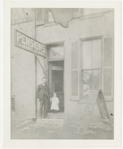 Andrew Jackson Fain and daughter, Bess (Mrs. Liberty Green) in front his real estate office