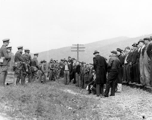 A crowd of miners confronting soldiers