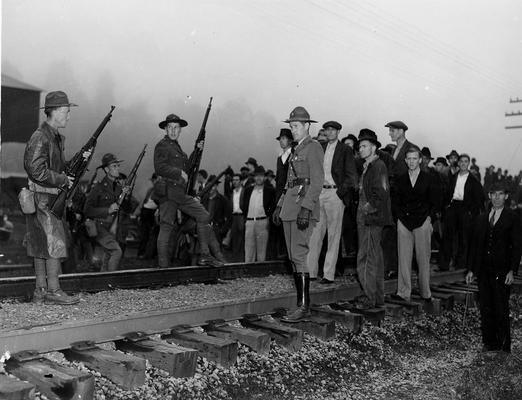 Troops confronting miners on a railroad track