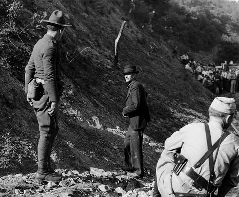 A National Guardsmen talking with an elderly man