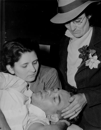 Two women with an injured man