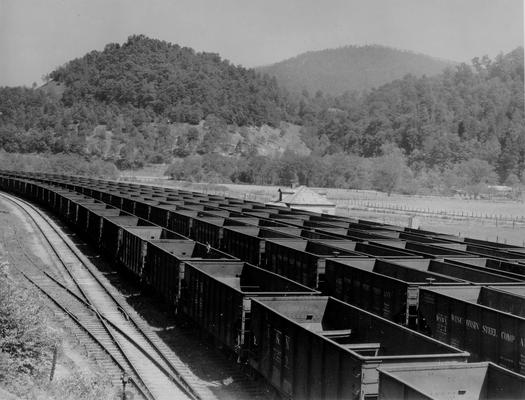 Strings of empty coal cars on railroad tracks