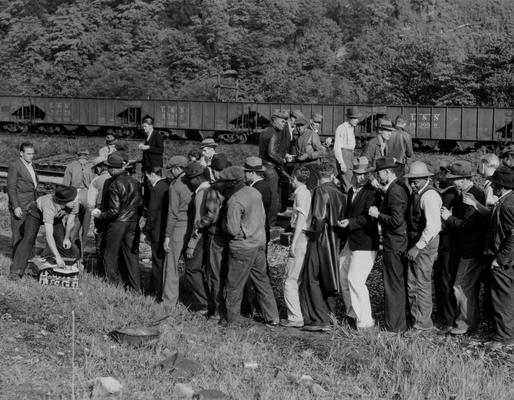 A crowd of miners lined up to pick up lunch