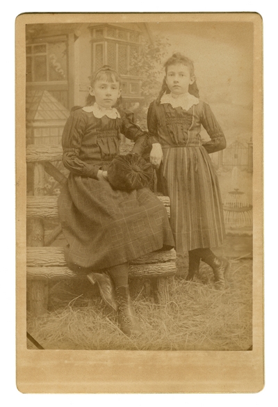 Portrait of two unidentified young ladies standing together