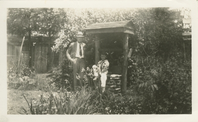 man and a boy outside by well