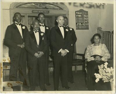 Group of African Americans in formal suits including Pastor Elder R.L. Saunders and Emma W. Saunders at an event for the East Second Street Christian Church, Lexington, Kentucky