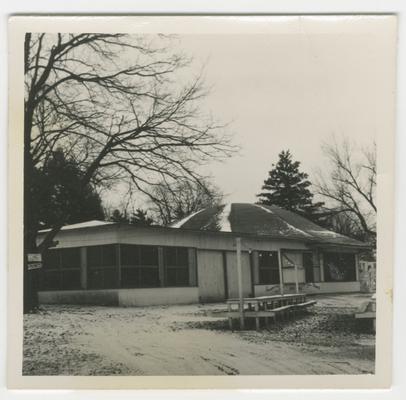 Picnic area with building behind tables, Joyland Park; side left view