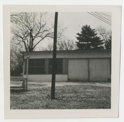 Half of building with two windows, pole in front, Joyland Park