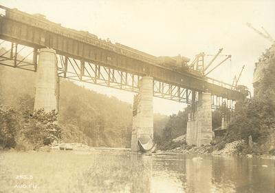 Trains and crane on High Bridge doing construction