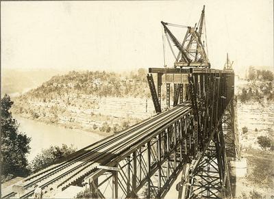 Construction on High Bridge-man beside CAUTION sign