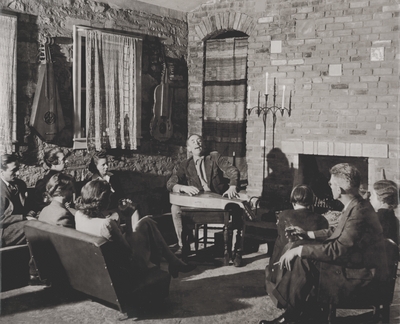 Performance by John Jacob Niles; Boot Hill Farm; Left to Right: (along the wall) Alex Kaporso, Doris Rannells, unidentified woman, (center) Lady Gwennifer Blennerhasset, Rena Niles, and Ted Rannells; Alfred Eisenstaedt