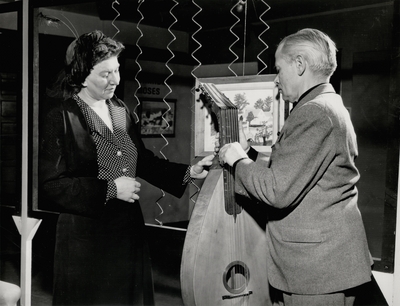 Promotional photo of John Jacob Niles and dulcimer with unidentified woman; Russ Scott, The Flint Journal; Flint, Michigan