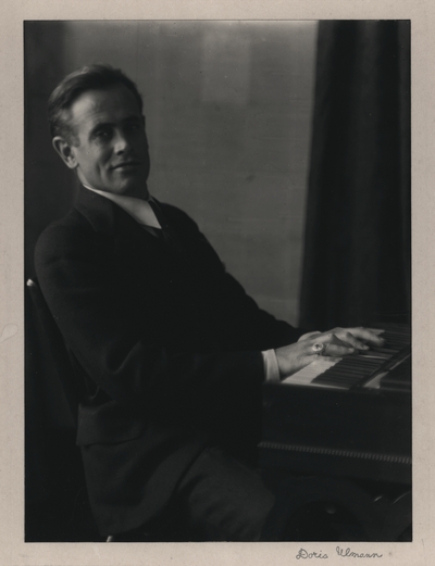 Portrait of John Jacob Niles seated at harpsichord owned by Doris Ulmann, taken at her apartment in New York City; Doris Ulmann-signed