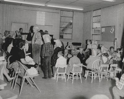 Performance by John Jacob Niles for children and dramatization of folk ballads by children; Harlan County, KY