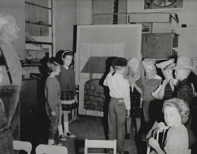 Performance by John Jacob Niles for children and dramatization of folk ballads by children; Harlan County, KY